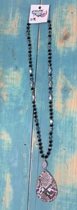 Long black bead with snake skin pendant
