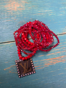 Red stretch bracelet set with upcycled charm